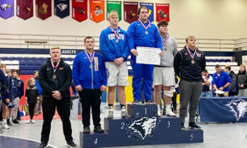 Dragons Wrestle at JCC Tournament Edwards stands on top of podium